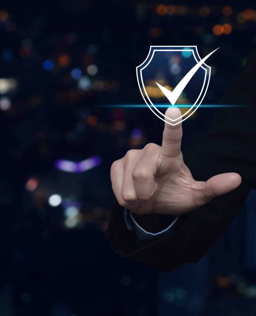 Businessman pressing security shield with check mark icon over blur colorful night light city tower and skyscraper, Technology internet cyber security and anti virus concept
